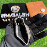 closeup of gold diamond iced out watch by pragalbh jewels showcasing roman numeral dial