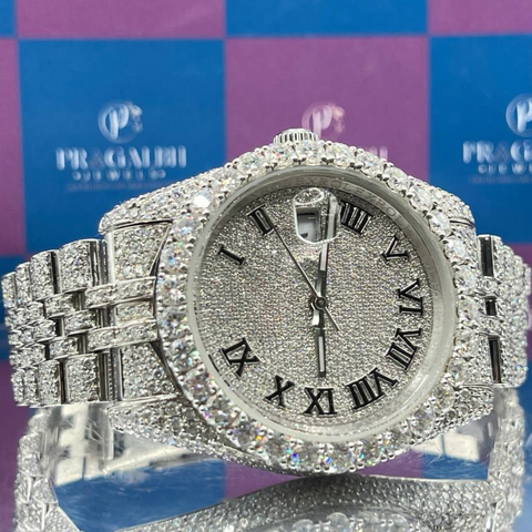 front closeup of silver iced out diamond watch by pragalbh jewels with roman numeral dial and luxury shine