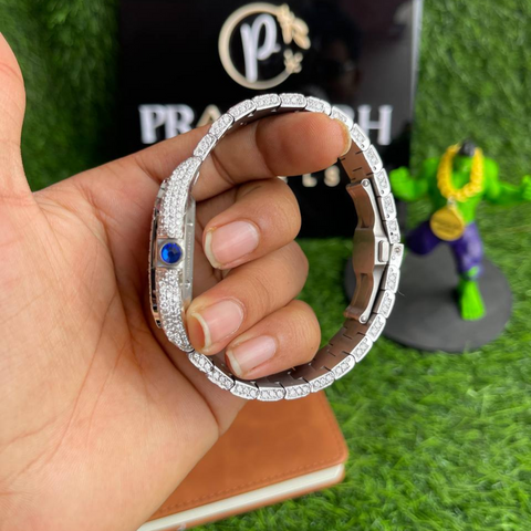 side profile of silver skeleton iced out watch with blue crown by pragalbh jewels